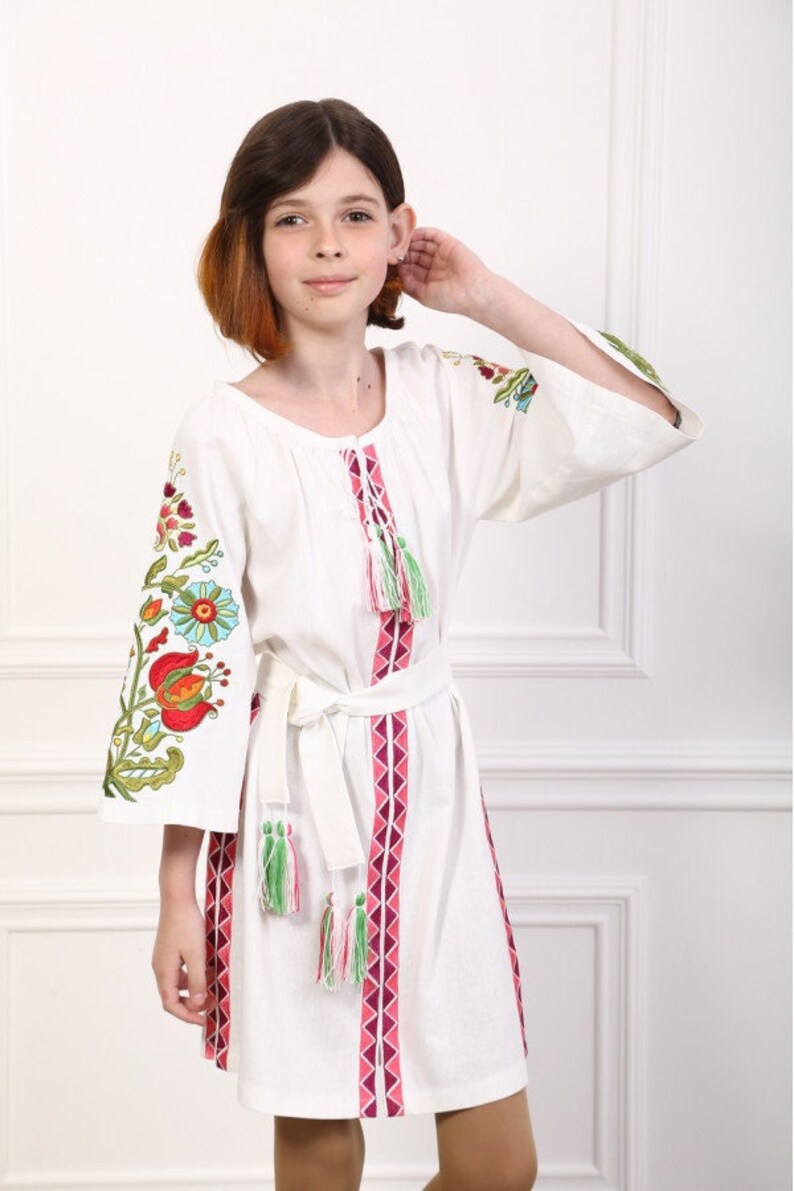 Hand-Embroidered White Cotton Floral Dress for Girls – Boho Tassel Tunic with Vibrant Sleeve Embroidery